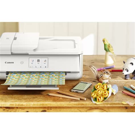 Canon printer on a wooden desk with stationery items