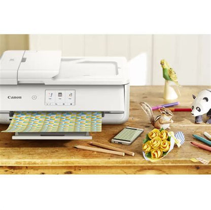 Canon printer on a wooden desk with stationery items